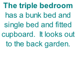The triple bedroom has a bunk bed and single bed and fitted cupboard.  It looks out to the back garden.